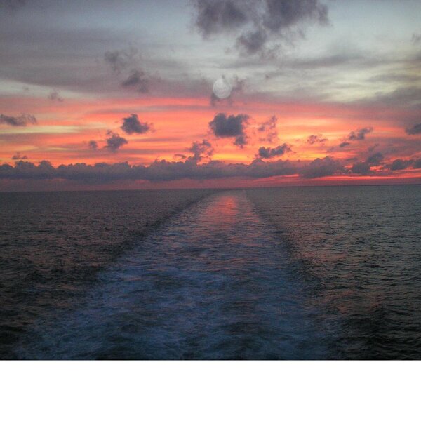 sunset with moonrise at sea